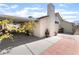 Side view of the home featuring a covered patio, extended roof line, and chimney at 1723 Candice St, Las Vegas, NV 89156