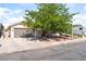 Charming single-story home with a spacious driveway and a large tree in the front yard at 1723 Candice St, Las Vegas, NV 89156