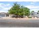 Charming single-story home with a well-maintained lawn and mature trees in the front yard at 1723 Candice St, Las Vegas, NV 89156