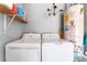 Functional laundry area with modern appliances, shelving, and overhead lighting at 1723 Candice St, Las Vegas, NV 89156
