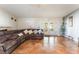 Open-concept living room features a large sectional sofa, tile floors, and decorative stone fireplace at 1723 Candice St, Las Vegas, NV 89156