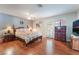 Primary bedroom with hardwood floors, a ceiling fan, and access to the backyard at 1723 Candice St, Las Vegas, NV 89156