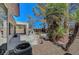 Cozy backyard with covered patio, outdoor kitchen, pond, and mature landscaping features at 2059 Joy View Ln, Henderson, NV 89012