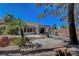 Relaxing backyard with covered patio, outdoor kitchen, mature landscaping, and decorative rock at 2059 Joy View Ln, Henderson, NV 89012