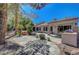 Expansive backyard featuring a built-in grill, covered patio, mature trees, and water feature at 2059 Joy View Ln, Henderson, NV 89012