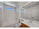 Bright bathroom featuring a shower-tub combo, modern vanity, and ample lighting at 2059 Joy View Ln, Henderson, NV 89012