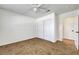 Bedroom featuring tile floors, a ceiling fan, closet, and a door to the hall at 2059 Joy View Ln, Henderson, NV 89012