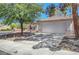 Charming single-story home with a two-car garage, lush tree, and low-maintenance front yard at 2059 Joy View Ln, Henderson, NV 89012