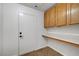 The laundry room features storage cabinets, tile floors and a folding counter at 2059 Joy View Ln, Henderson, NV 89012