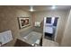 Bathroom featuring a large bathtub and doorway to a bedroom with two queen sized beds at 211 E Flamingo Rd # 405, Las Vegas, NV 89169