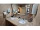 Bathroom with a double sink vanity, granite countertop, and well-lit mirror at 211 E Flamingo Rd # 405, Las Vegas, NV 89169