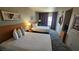 Bedroom featuring two queen beds with a modern headboard, lamps, and patterned drapes at 211 E Flamingo Rd # 405, Las Vegas, NV 89169