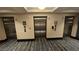 Elevator lobby with multiple elevators and patterned carpeting at 211 E Flamingo Rd # 405, Las Vegas, NV 89169