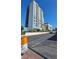 View of The Flair residential building with blue sky, surrounding landscaping, and convenient parking at 211 E Flamingo Rd # 405, Las Vegas, NV 89169