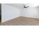 Bright, freshly painted bedroom with wood laminate flooring and a modern ceiling fan at 2112 Los Altos St, Las Vegas, NV 89102