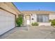 View of the front exterior, showcasing the home's entrance, garage, and neatly kept landscaping at 2112 Los Altos St, Las Vegas, NV 89102
