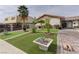 Lush front yard features artificial grass, mature palm trees, and a brick driveway at 2112 Los Altos St, Las Vegas, NV 89102