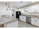 Well-appointed kitchen featuring updated appliances, granite countertops, and stylish pendant lighting at 2112 Los Altos St, Las Vegas, NV 89102