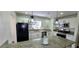 Renovated kitchen with granite countertops, stainless steel appliances, and modern pendant lights at 2112 Los Altos St, Las Vegas, NV 89102