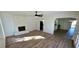 Open-concept living room with a stone fireplace, ceiling fan, and wood-look flooring at 2112 Los Altos St, Las Vegas, NV 89102