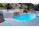Backyard oasis with a stunning pool, rock waterfall, spa, and fire pit for ultimate relaxation at 2197 Big Bar Dr, Henderson, NV 89052