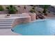 Resort-style pool with waterfall feature, fire pit, and lush landscaping creates a backyard oasis at 2197 Big Bar Dr, Henderson, NV 89052