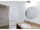 Bathroom featuring a granite-look vanity and a circular mirror, providing a modern feel at 2313 Van Patten Pl, Las Vegas, NV 89104