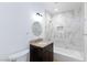 Bathroom featuring a granite-look vanity and tub/shower combo with marble-look tile surround at 2313 Van Patten Pl, Las Vegas, NV 89104