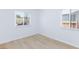 Bedroom with new flooring, white walls, and natural light from two windows at 2313 Van Patten Pl, Las Vegas, NV 89104