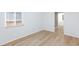 Bright bedroom featuring light wood floors and a glimpse into the ensuite bathroom at 2313 Van Patten Pl, Las Vegas, NV 89104
