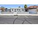 Charming single-story home featuring a block wall and decorative iron fencing for added curb appeal and security at 2313 Van Patten Pl, Las Vegas, NV 89104