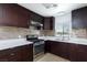 Modern kitchen featuring new appliances, bright countertops, and dark wood cabinets at 2313 Van Patten Pl, Las Vegas, NV 89104