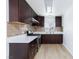 Beautiful kitchen boasts dark wood cabinets, new appliances, and tiled backsplash at 2313 Van Patten Pl, Las Vegas, NV 89104