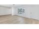 Bright living room featuring wood-look flooring, fresh white walls, and a large window at 2313 Van Patten Pl, Las Vegas, NV 89104