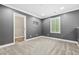 Cozy bedroom features neutral paint, carpet, a window, and white trim at 2385 Via Firenze, Henderson, NV 89044