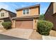 Charming two-story home with a well-manicured lawn and an attached two-car garage at 2385 Via Firenze, Henderson, NV 89044