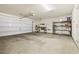 Spacious garage with ample room for parking and storage, featuring shelving units at 2385 Via Firenze, Henderson, NV 89044