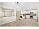 A spacious open-concept kitchen with stainless steel appliances and white cabinetry at 2385 Via Firenze, Henderson, NV 89044