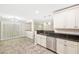 Updated kitchen with stainless steel appliances and granite countertops open to dining area at 2385 Via Firenze, Henderson, NV 89044