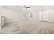 Bright living room featuring neutral paint, carpet, and an entry door at 2385 Via Firenze, Henderson, NV 89044
