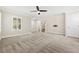 Spacious living room featuring a modern ceiling fan and neutral carpet at 2385 Via Firenze, Henderson, NV 89044