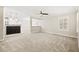 Open living space with neutral tones, plush carpet, and large windows at 2385 Via Firenze, Henderson, NV 89044