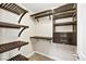 Custom walk-in closet featuring dark wood shelving and drawers for ample storage space at 2385 Via Firenze, Henderson, NV 89044