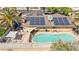 Aerial view of a home with a pool, covered patio, solar panels, and well-manicured landscaping at 2426 La Pluma St, Henderson, NV 89014