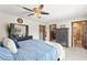 Bedroom with closet and bathroom access, large windows, and calming color scheme at 2426 La Pluma St, Henderson, NV 89014