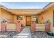 Inviting entryway with a charming wood door, brick pillars, stone landscape and decorative elements creating a welcoming atmosphere at 2426 La Pluma St, Henderson, NV 89014
