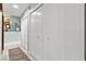Hallway with multiple closets and neutral color scheme featuring a decorative area rug at 2426 La Pluma St, Henderson, NV 89014