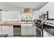 Modern kitchen featuring stainless steel appliances, white cabinetry, butcher block counters and a garden window with natural light at 2426 La Pluma St, Henderson, NV 89014