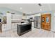 Bright kitchen featuring white cabinets, stainless steel appliances, a center island, and stylish tile flooring at 2426 La Pluma St, Henderson, NV 89014