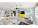 Open-concept living area with a vibrant yellow cabinet, comfortable seating, and playful decor at 2426 La Pluma St, Henderson, NV 89014